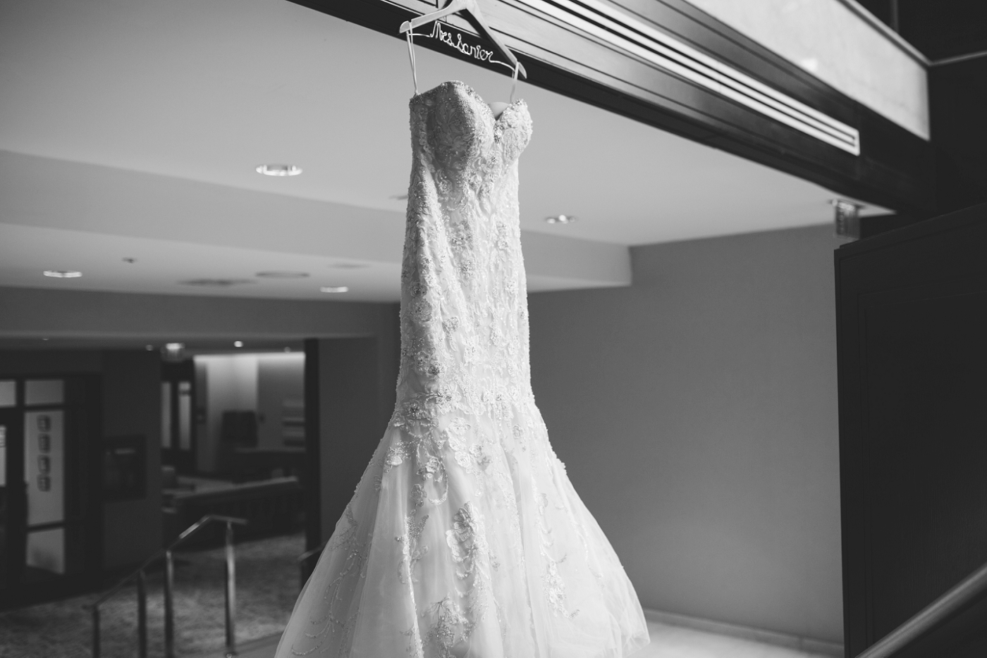 bridal gown hanging in hallway
