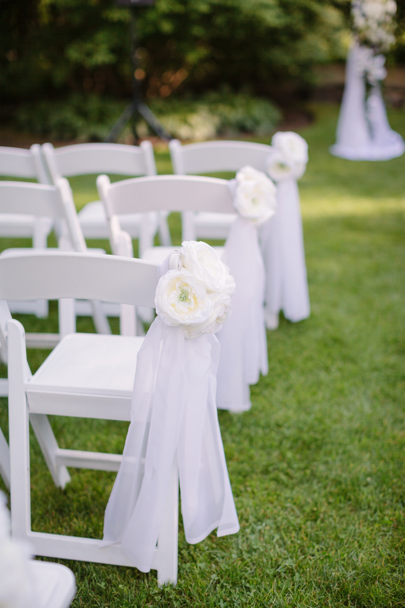 white chairs for outdoor wedding ceremony