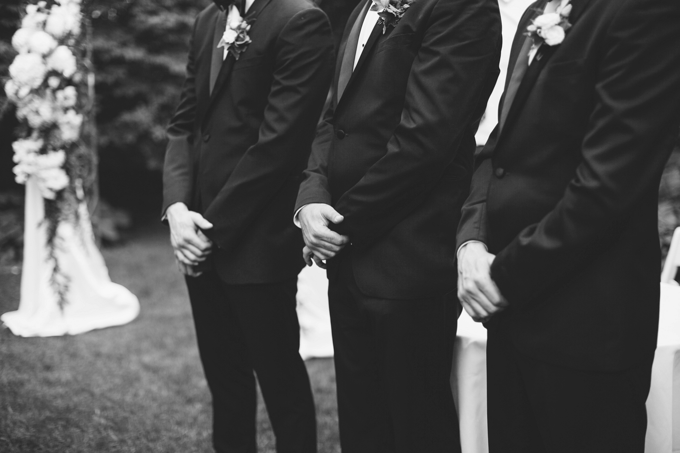 groomsmen hands folded at wedding ceremony