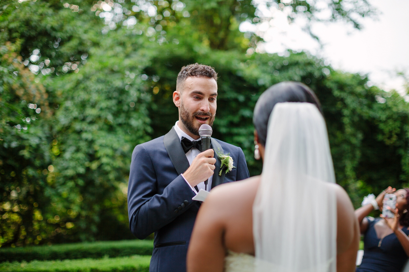 groom reciting wedding vows he wrote to the groom