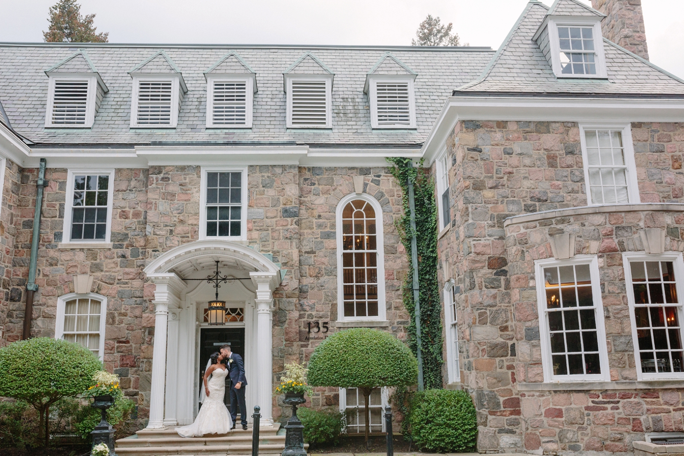 Bride and groom outside of McLean House at Estates of Sunnybrook
