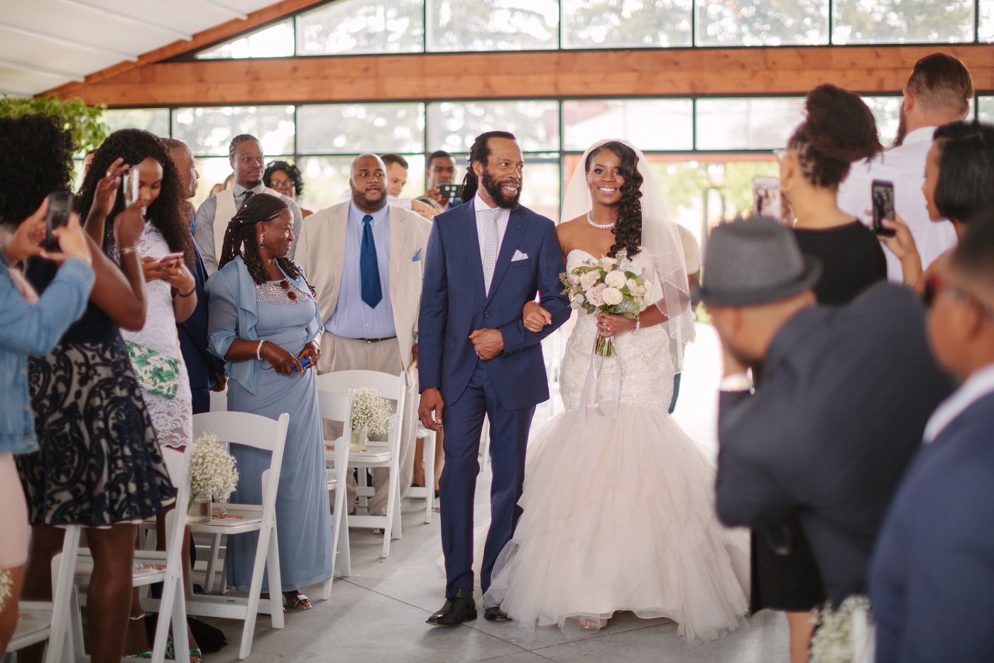 bride walking down the aisle with jamaican dad