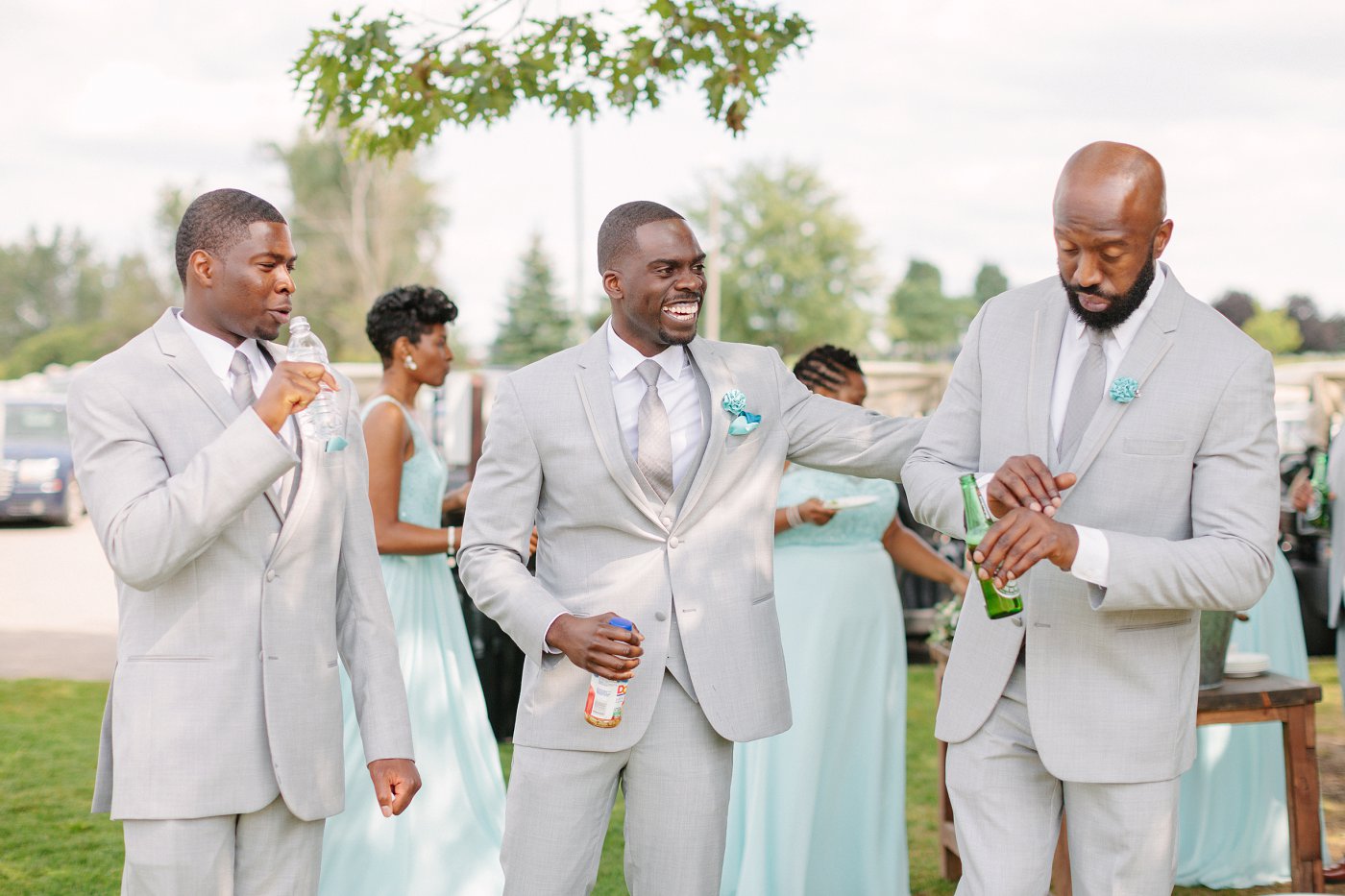 groomsmen joking around at wedding ceremony