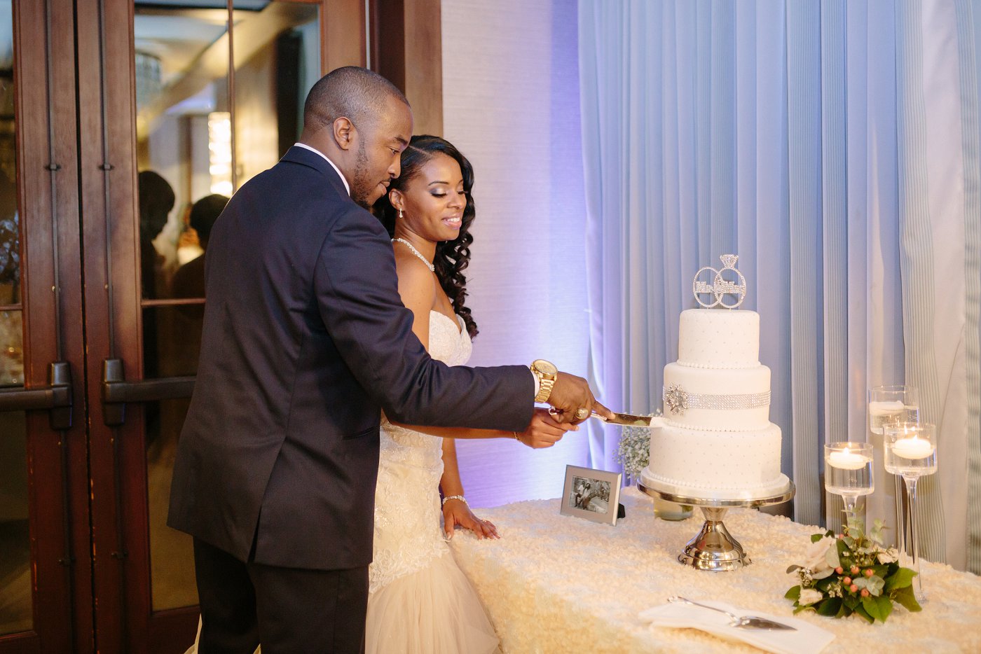 black bride and groom cutting wedding cake
