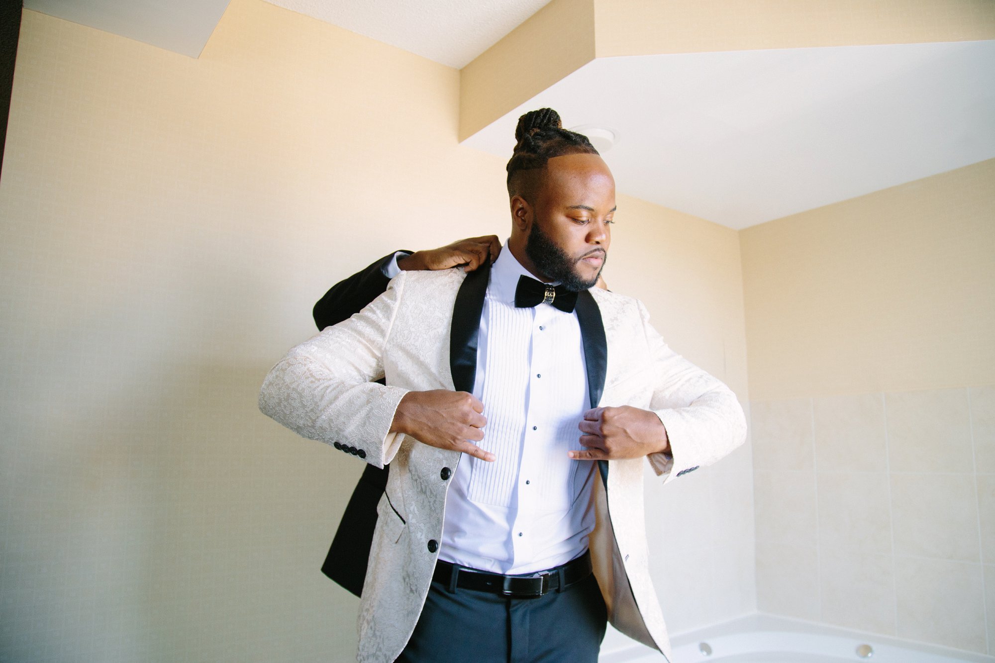 Groom in white tux jacket