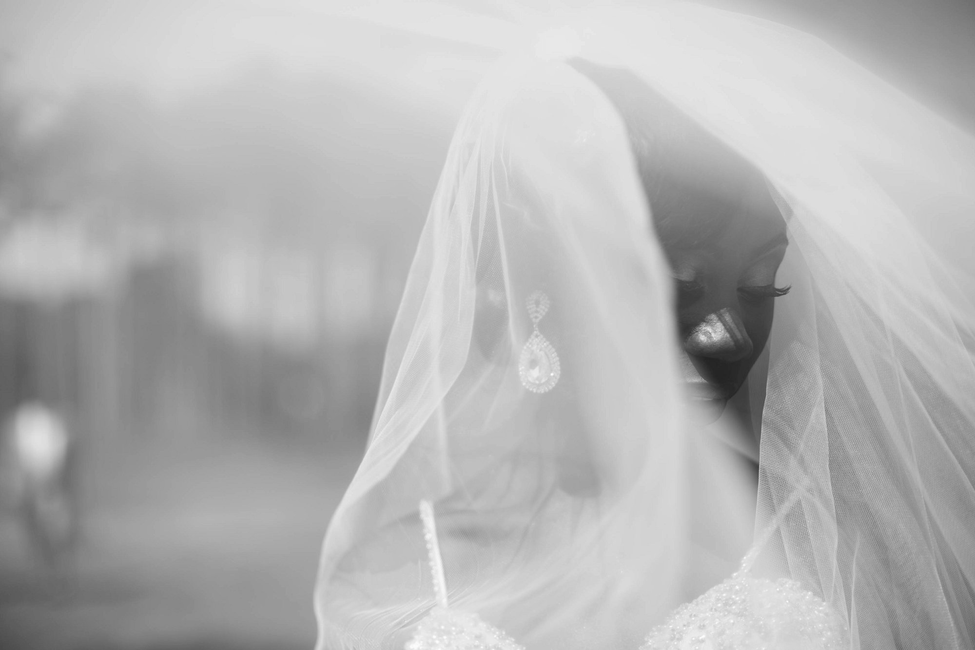 Bride covered by veil on wedding day