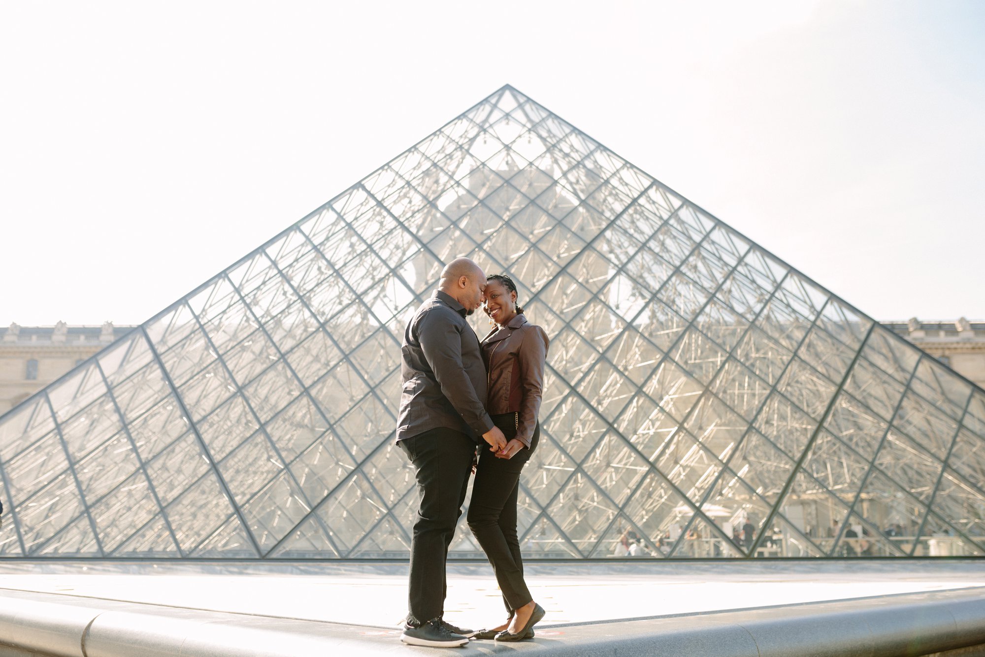 symmetrical photo shoot at the louvre museum in paris during romantic engagement photo shoot
