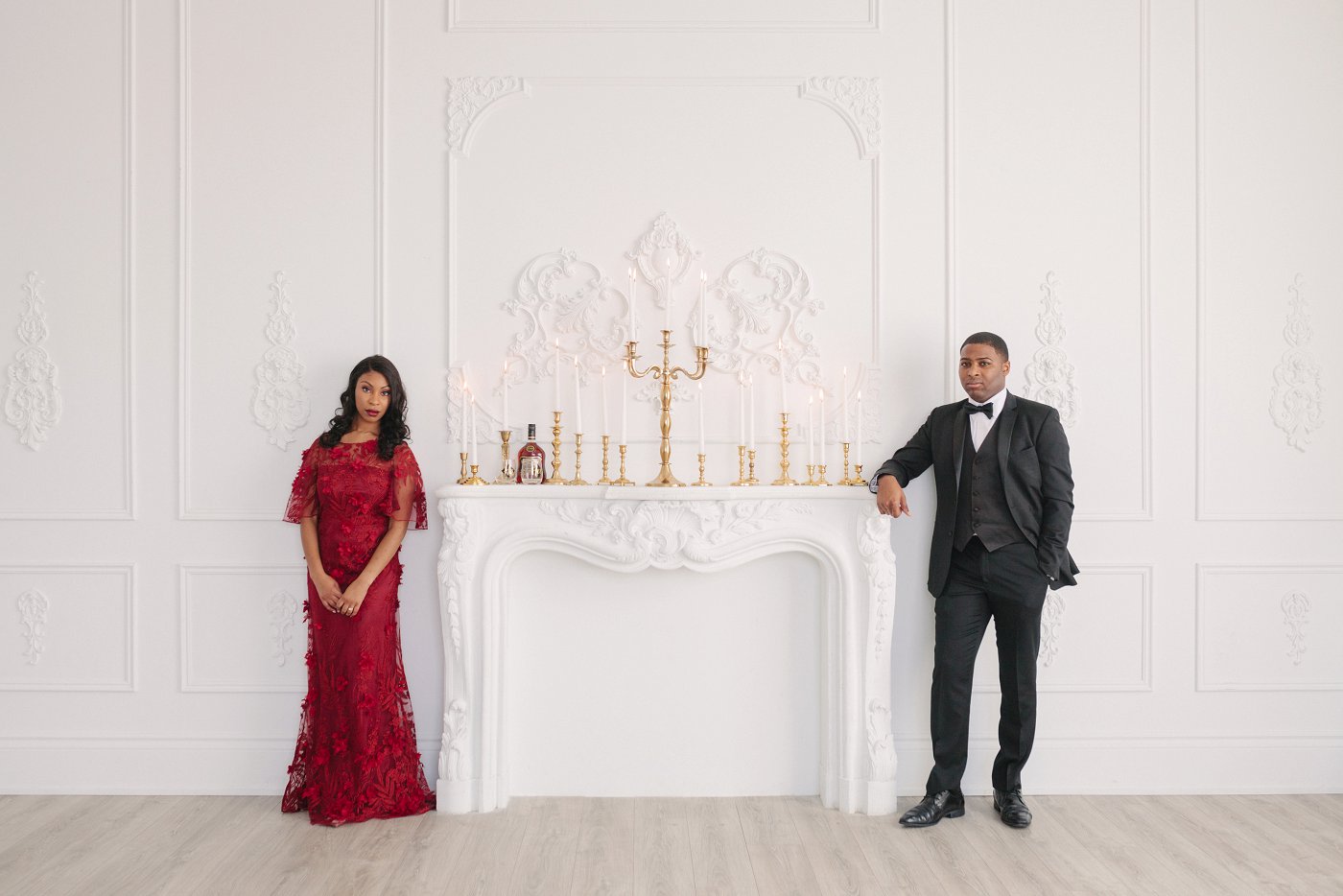Gold candelabras in formal engagement session with couple