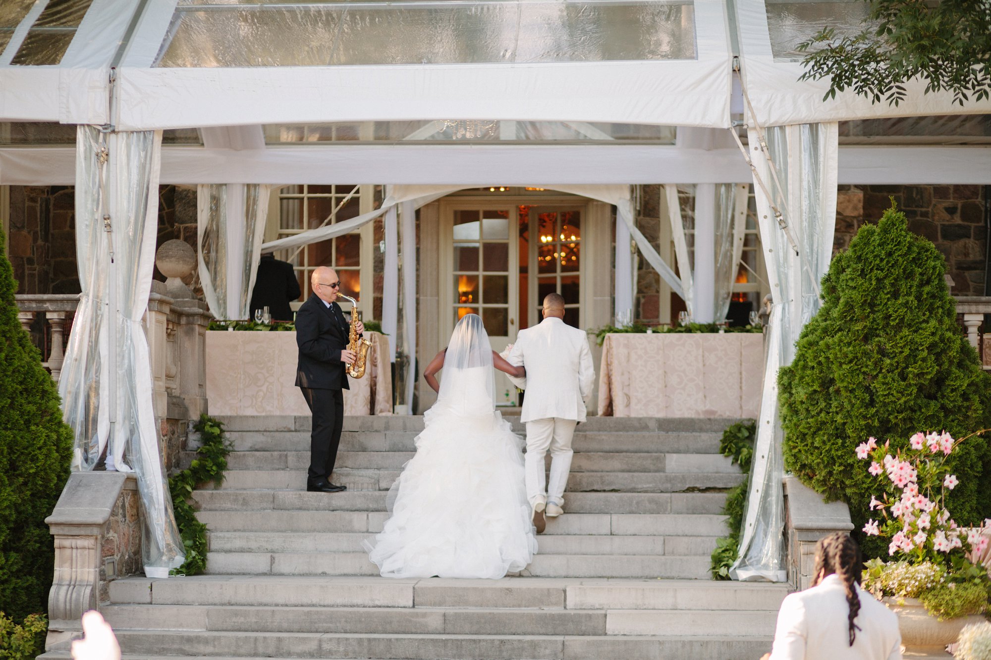 bride and groom walking with live saxophone player