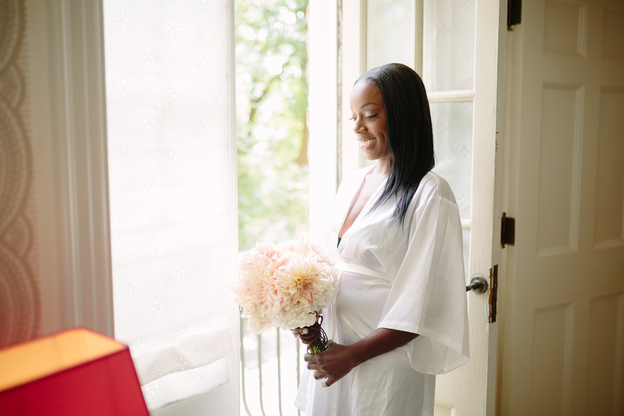 bride wearing white robe in bridal suite at graydon hall manor
