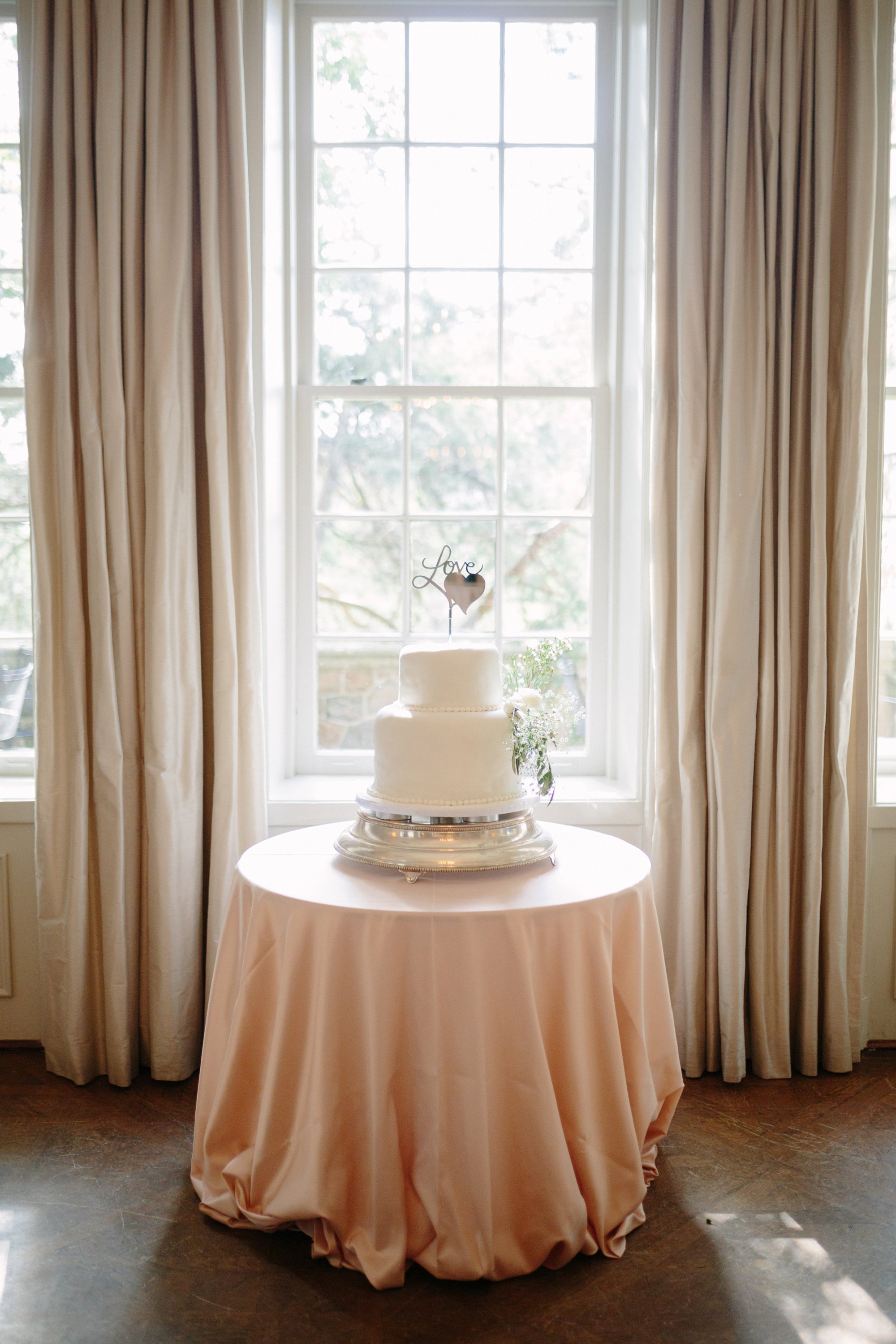 bride and groom's all white wedding cake