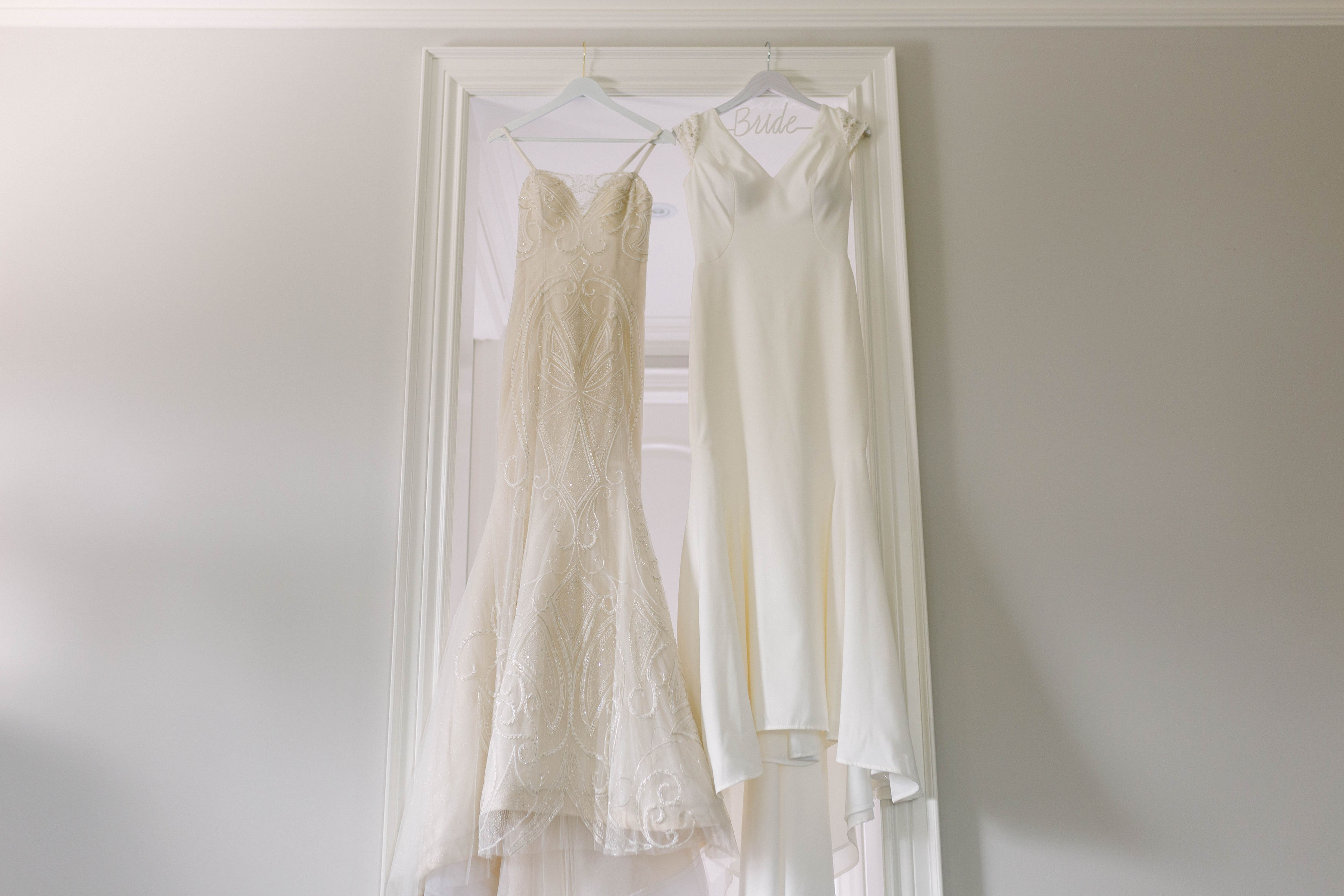 Bride's two dresses hanging in bridal suite