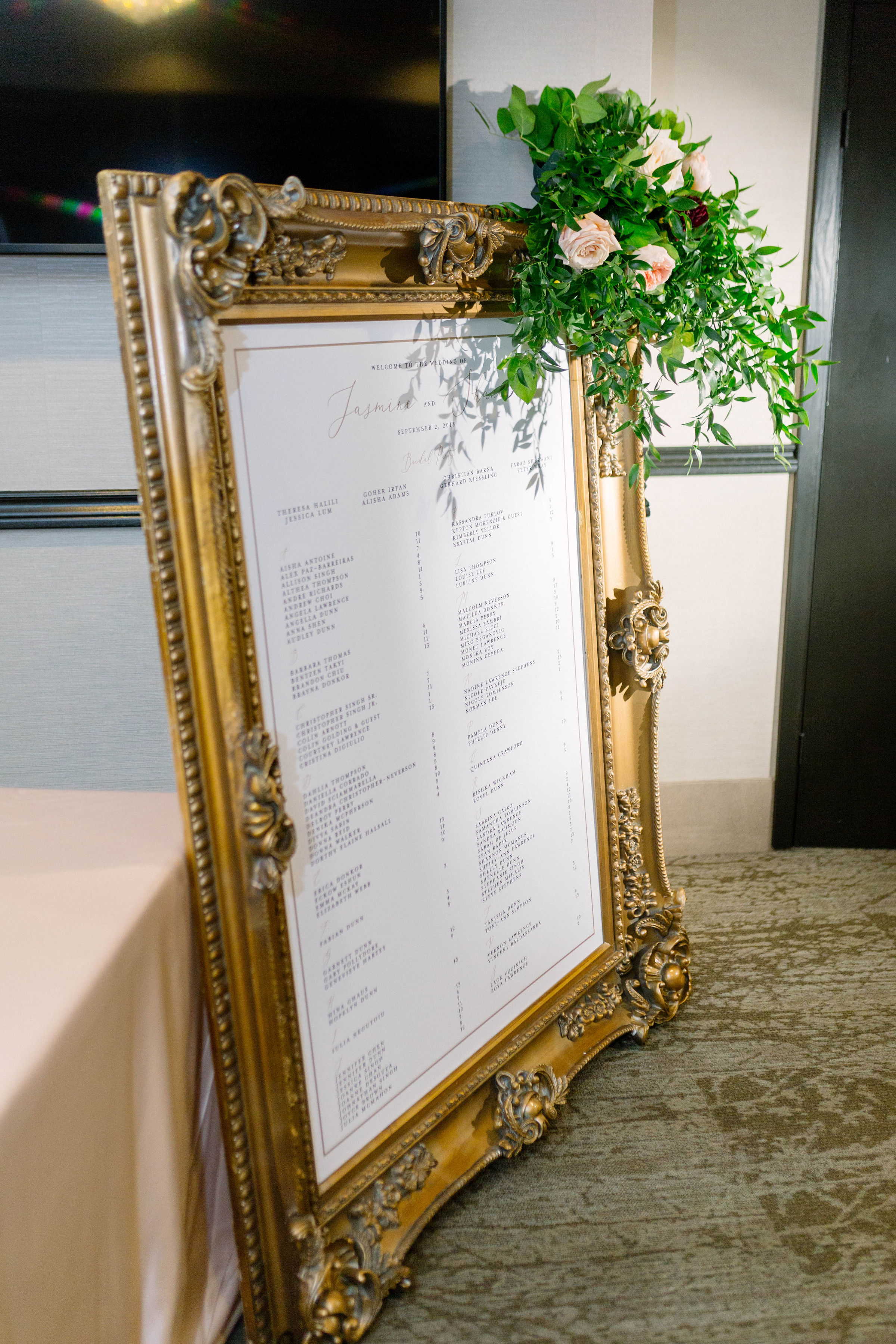 Custom seating chart with gold frame and calligraphy at The Manor by Peter and Paul's