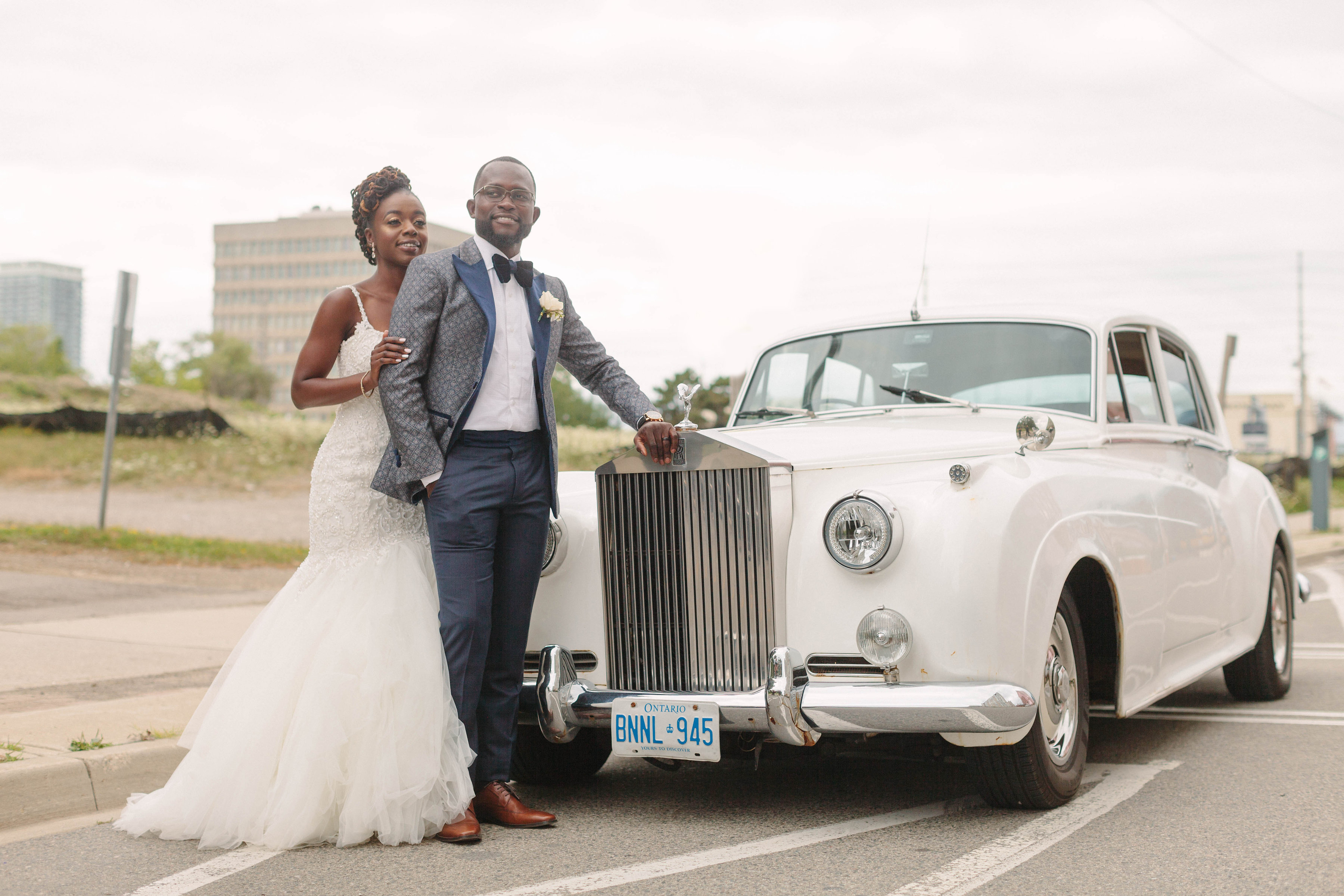 bride and groom at car