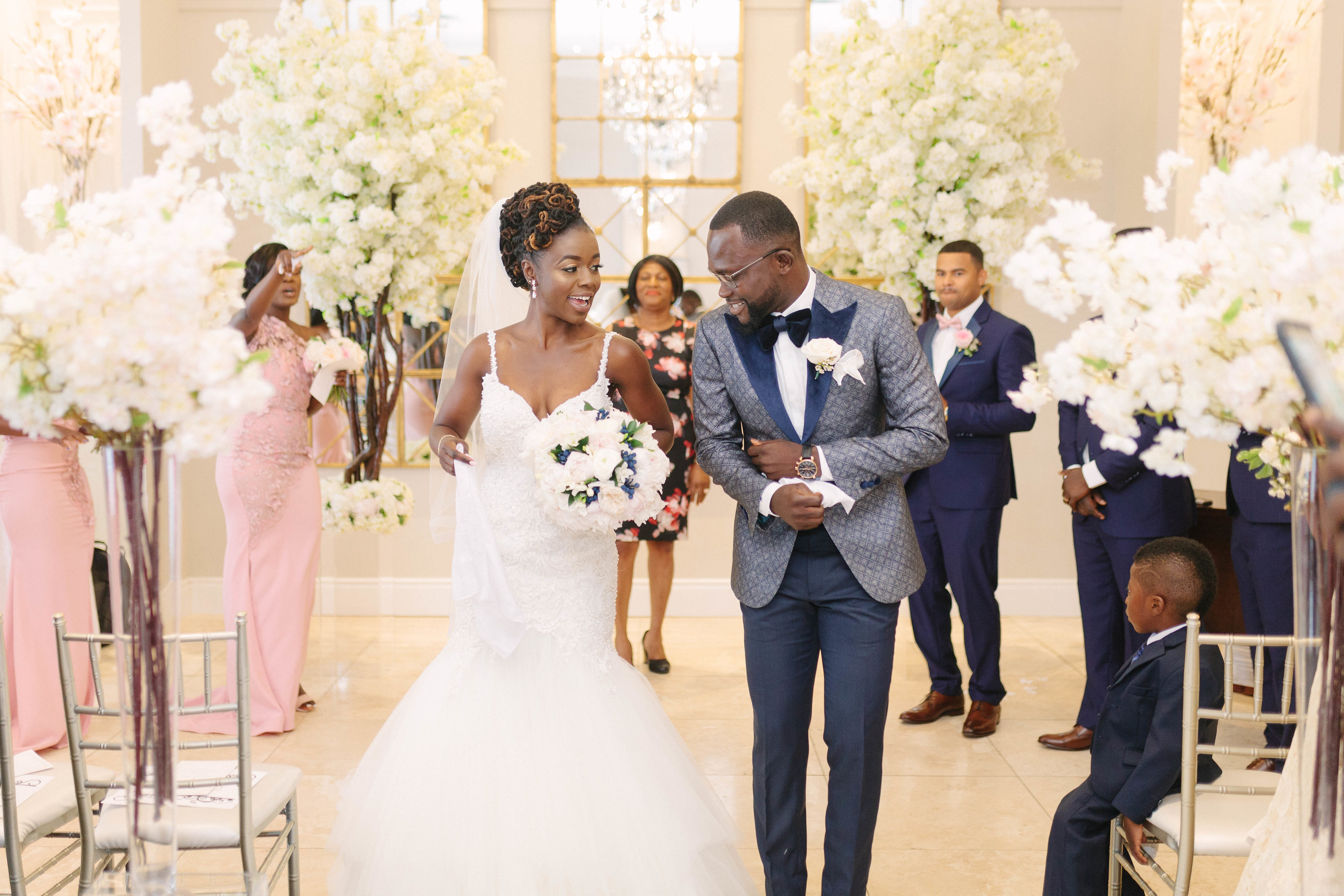 bride and groom walk down aisle