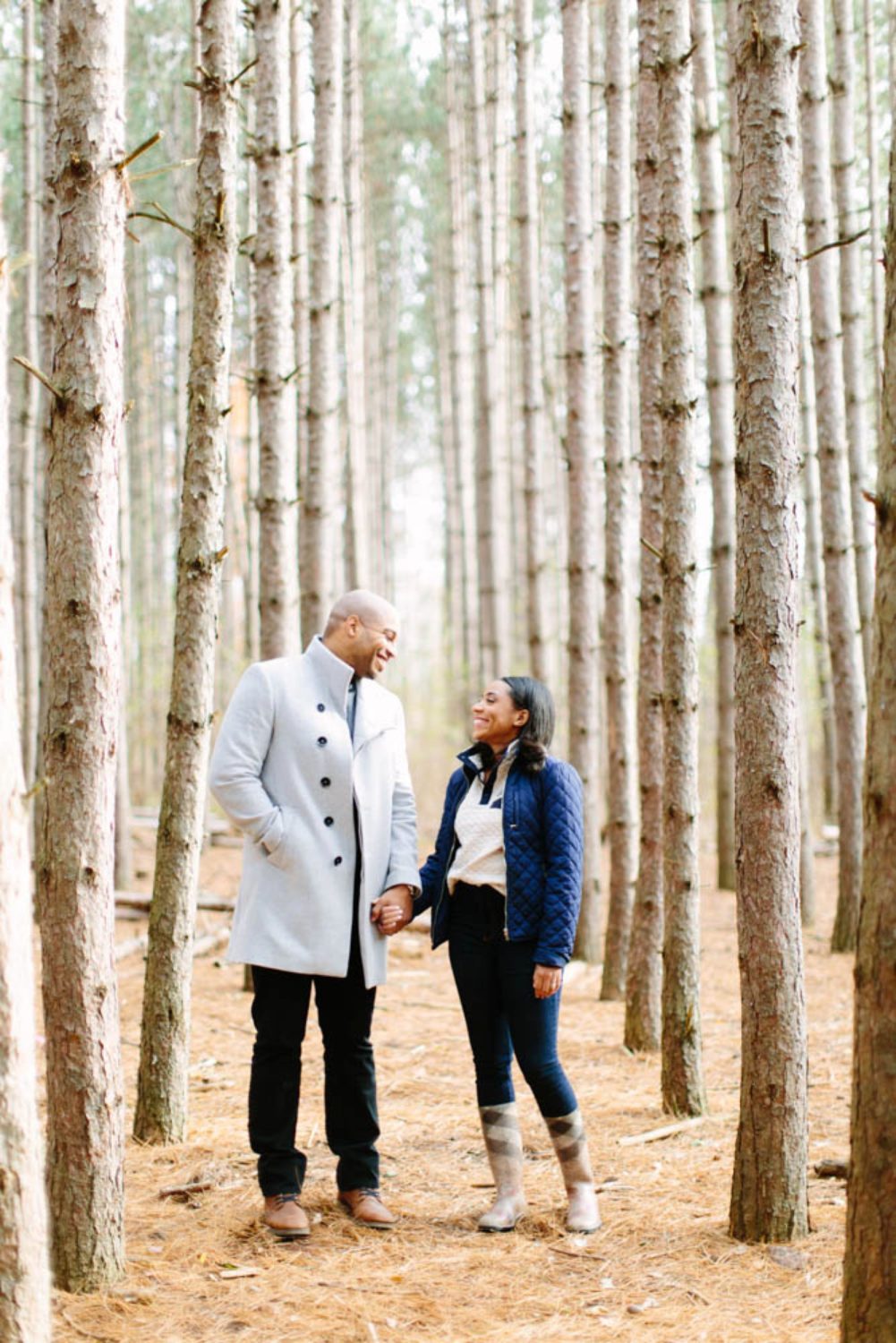 A couple standing looking at each other with tall birch trees surrounding them at Kortright Centre. 