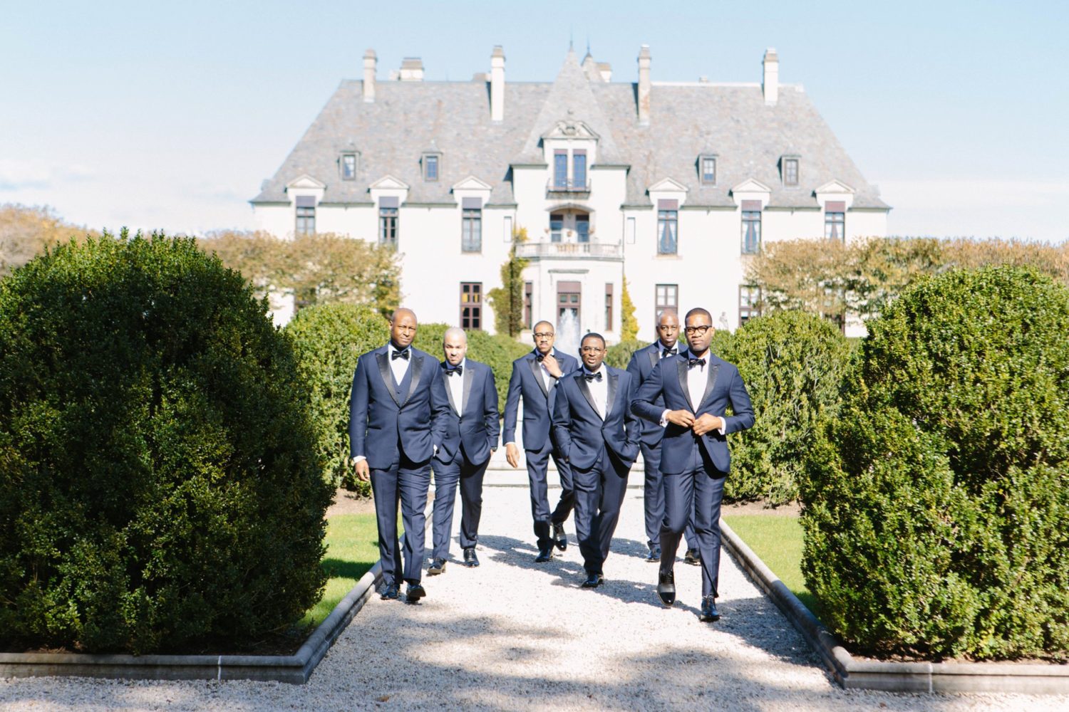 Groom and groomsmen walking from Oheka Castle, New York wedidng photography,