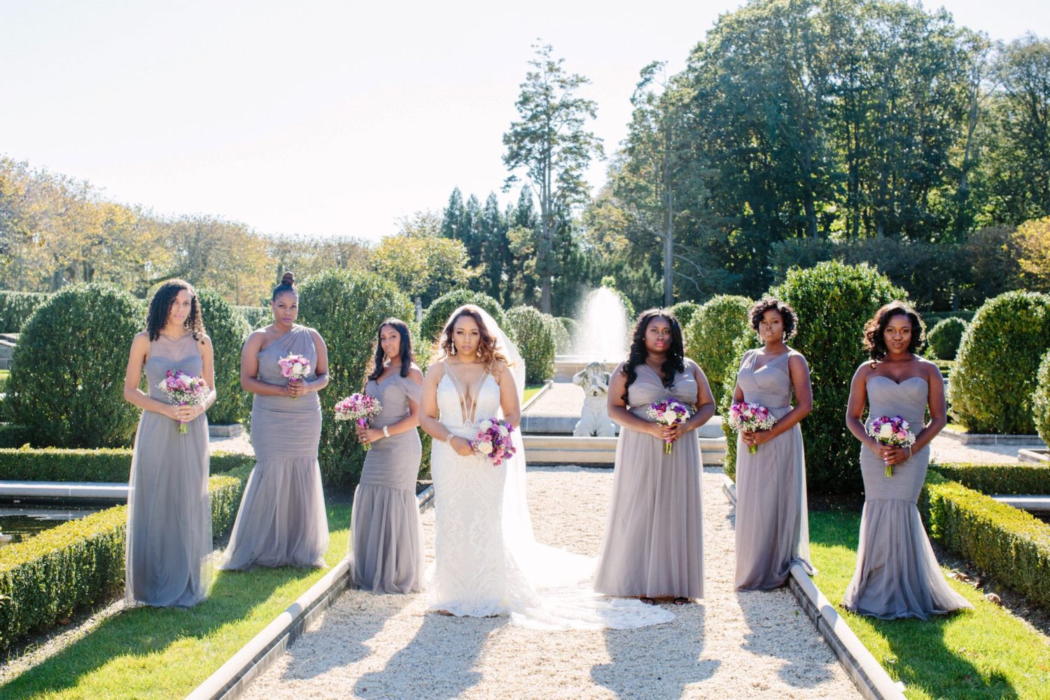 Bride and bridesmaids outside of Oheka Castle, New York wedding photography.