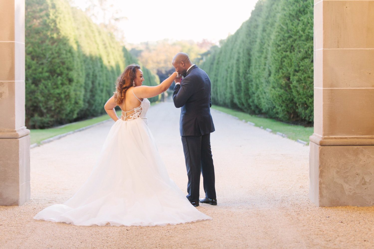 Groom kissing his bride outside of Oheka Castle, Long Island.