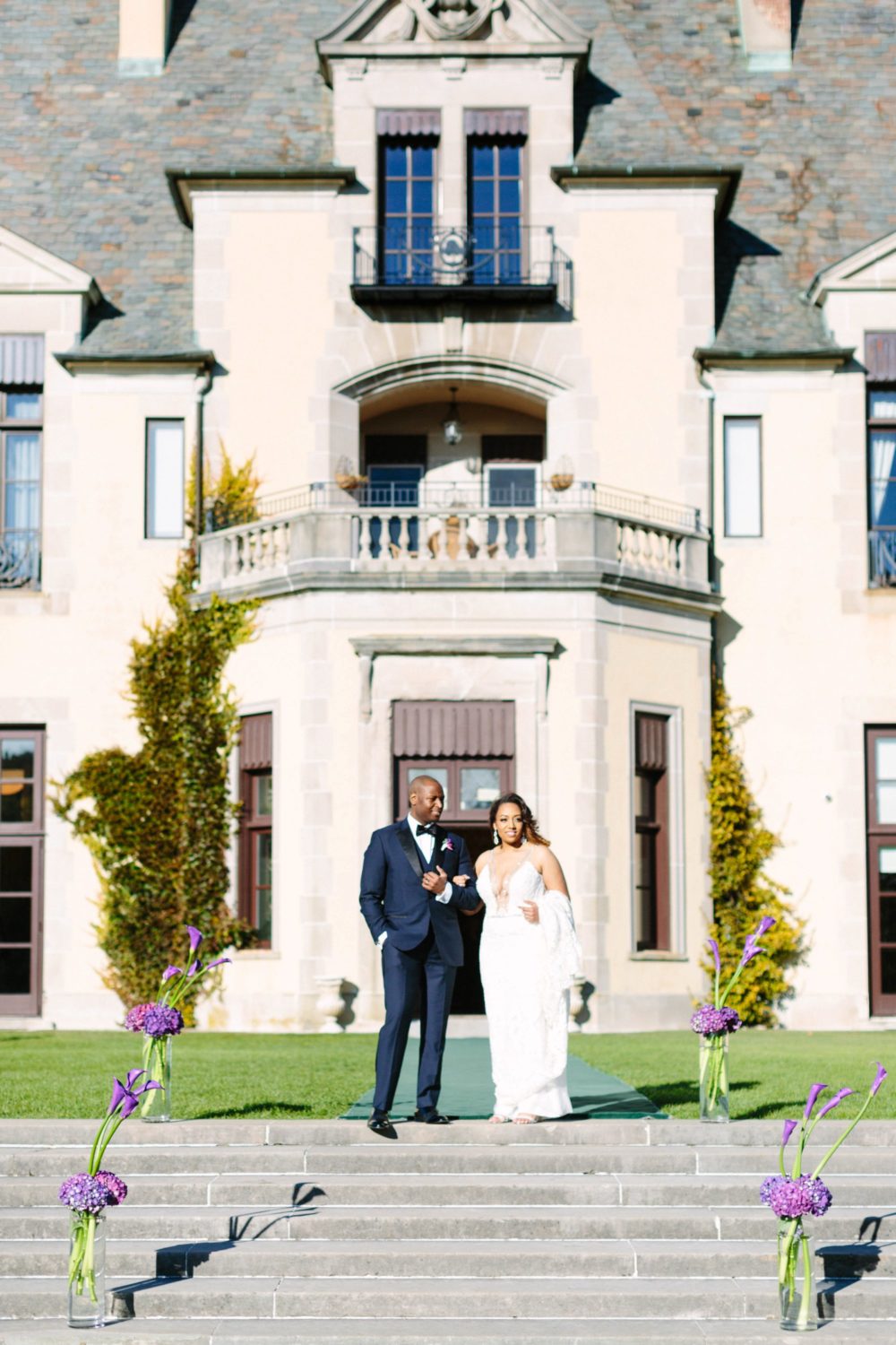 Bride and Groom standing out side of Oheka Castle.