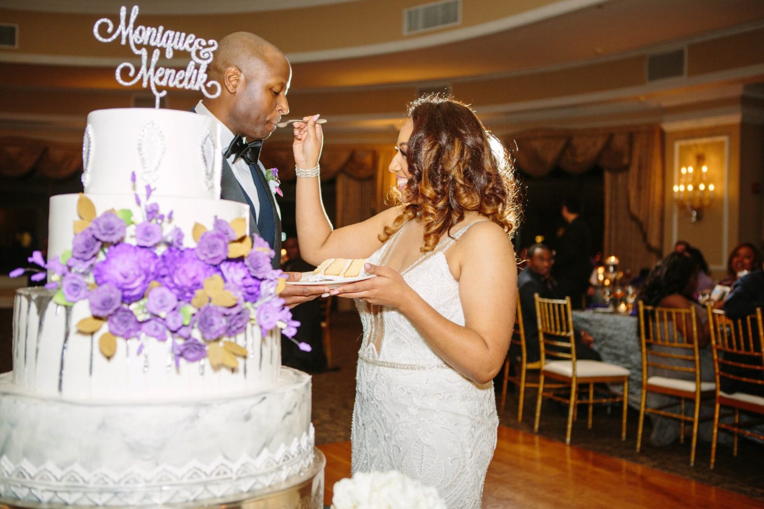 Bride feeding cake to groom, Oheka Castle wedding photography.