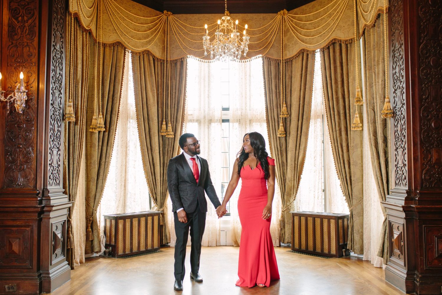 Couple holding hands in Oak Room at Casa Loma.