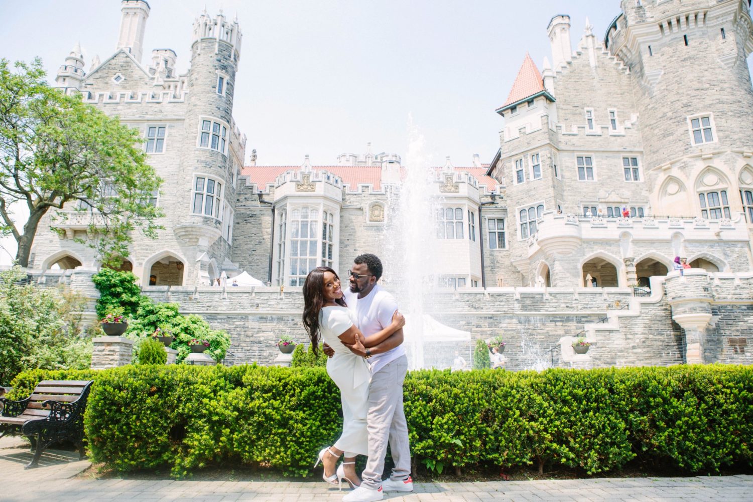 Couple hugging in front of Casa Loma.