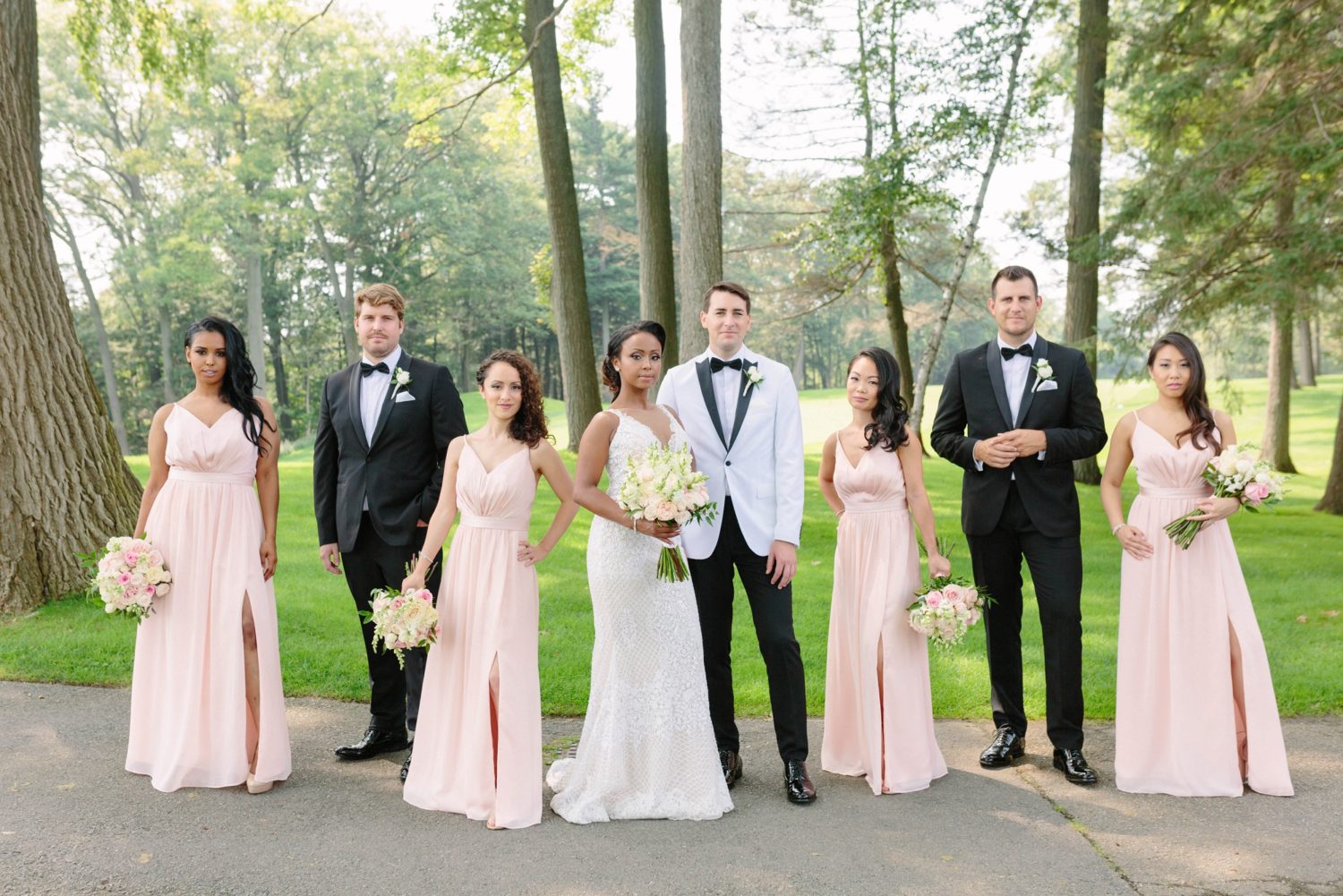 Uneven number of groomsmen and bridemaids. Black tie wedding with pink and white dresses